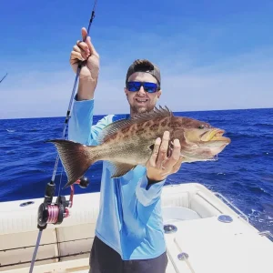 Captain Brock of Grinning Angler Charters holding a nice grouper