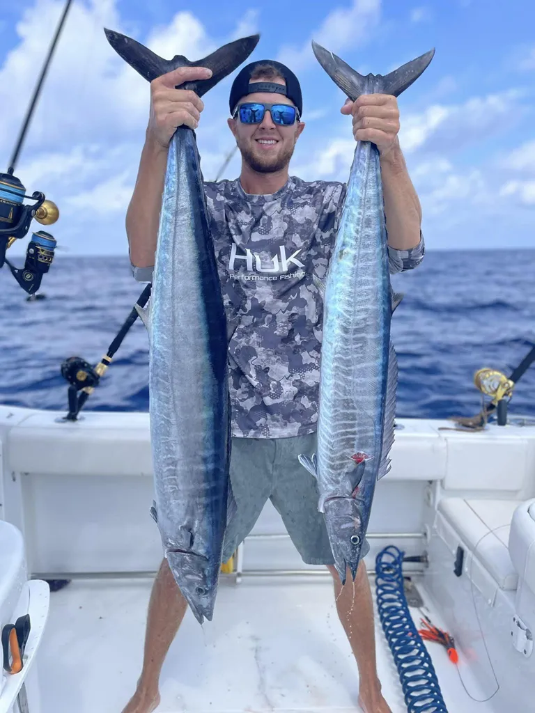 Captain Brock of Grinning Angler Charters holding 2 wahoo